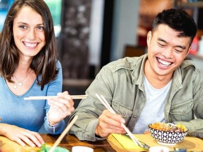 Group of friends eat sushi together.
