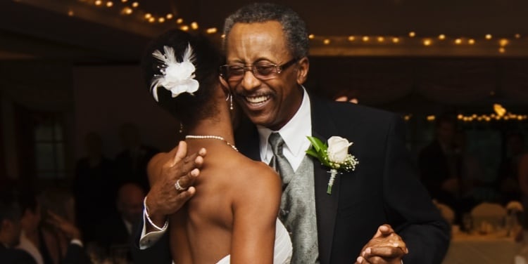Man hugging his daughter at her wedding