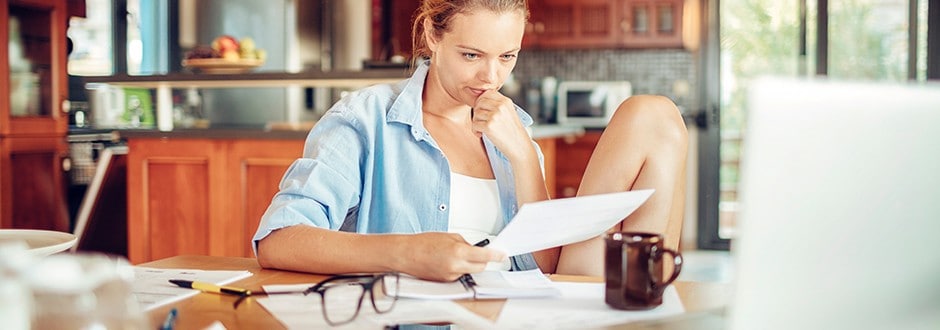Young woman looking at her longstanding debt and considering the best way to consolidate it.