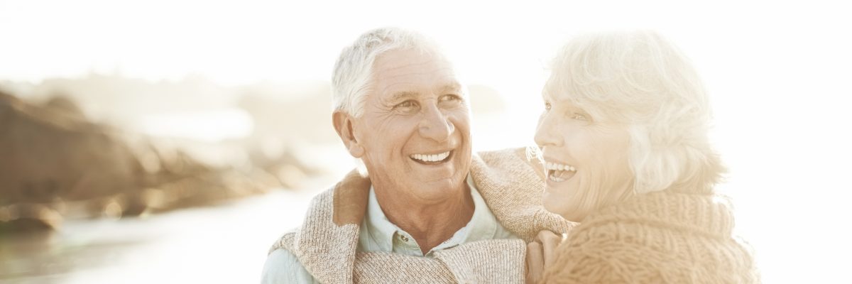 Retired couple enjoying sunset at the lake