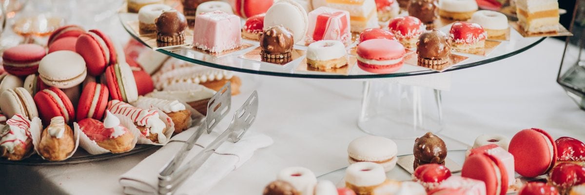 A selection of pink and white macaroons, canolis and other pastries.