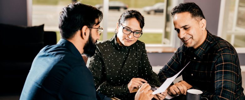 A couple discusses their finances with a financial planner.